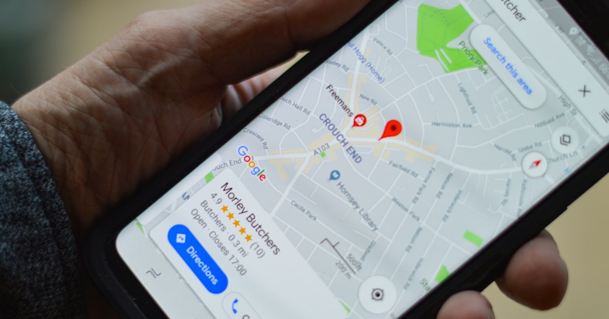 Phone showing a local business listing with reviews and directions on Google Maps